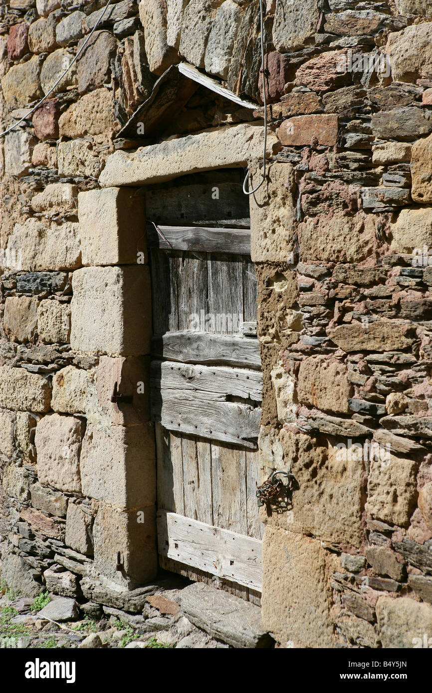 Stone wall with old door Stock Photo - Alamy
