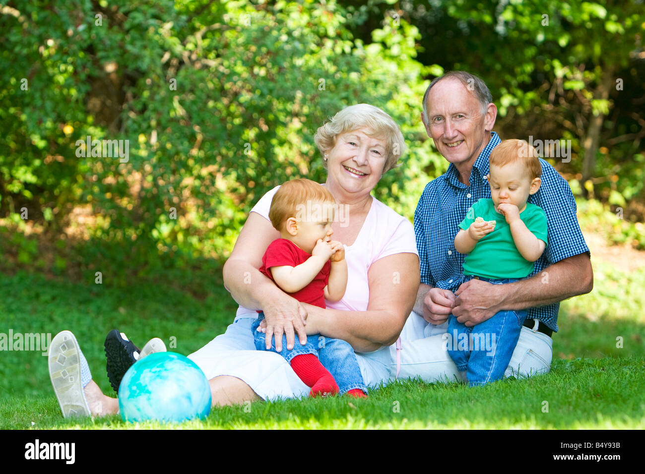 happy-handsome-grandparents-with-twin-grandsons-outdoor-portrait-stock