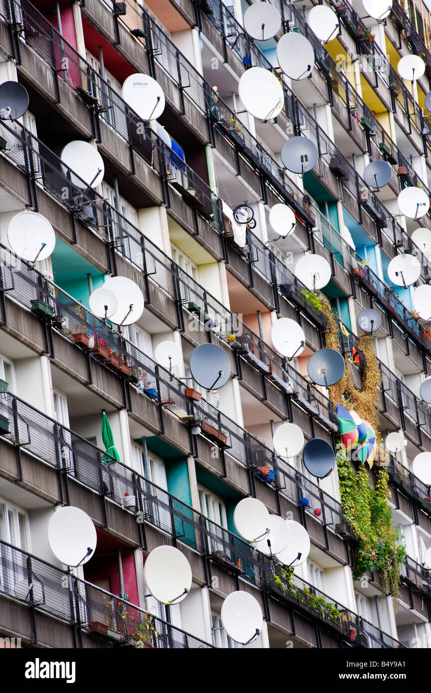 Many satellite dishes fixed to balconies of apartment building built as social housing at