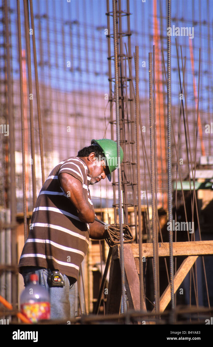 Construction worker putting up steel framework in harbour as part of dock reconstruction project, Iquique, Chile Stock Photo