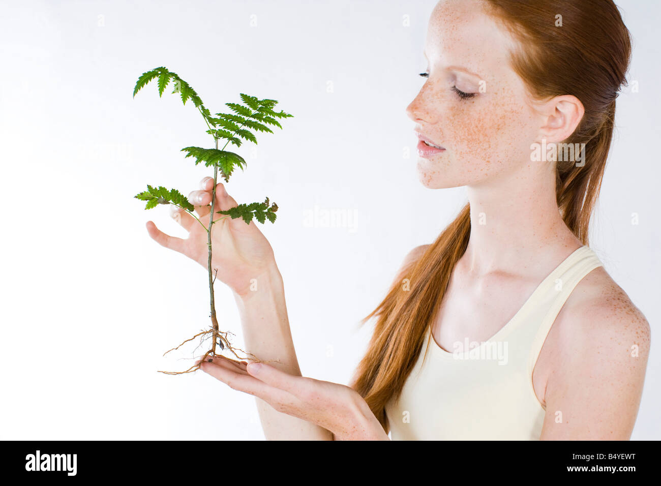 young woman with plant Stock Photo