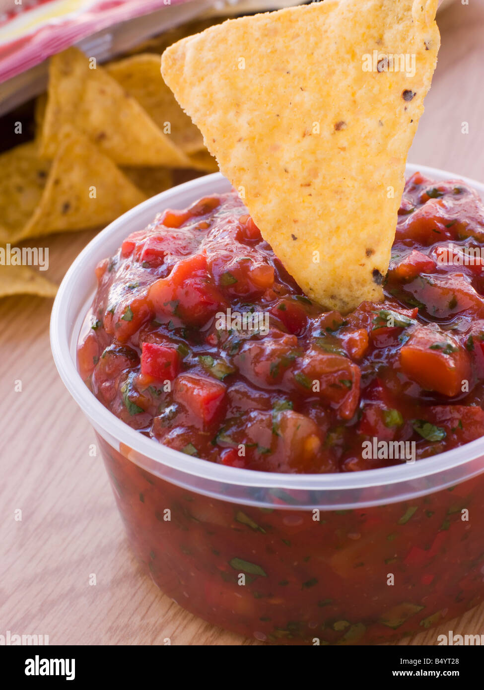 Pot Of Tomato And Coriander Salsa With A Corn Tortilla Chip Stock Photo