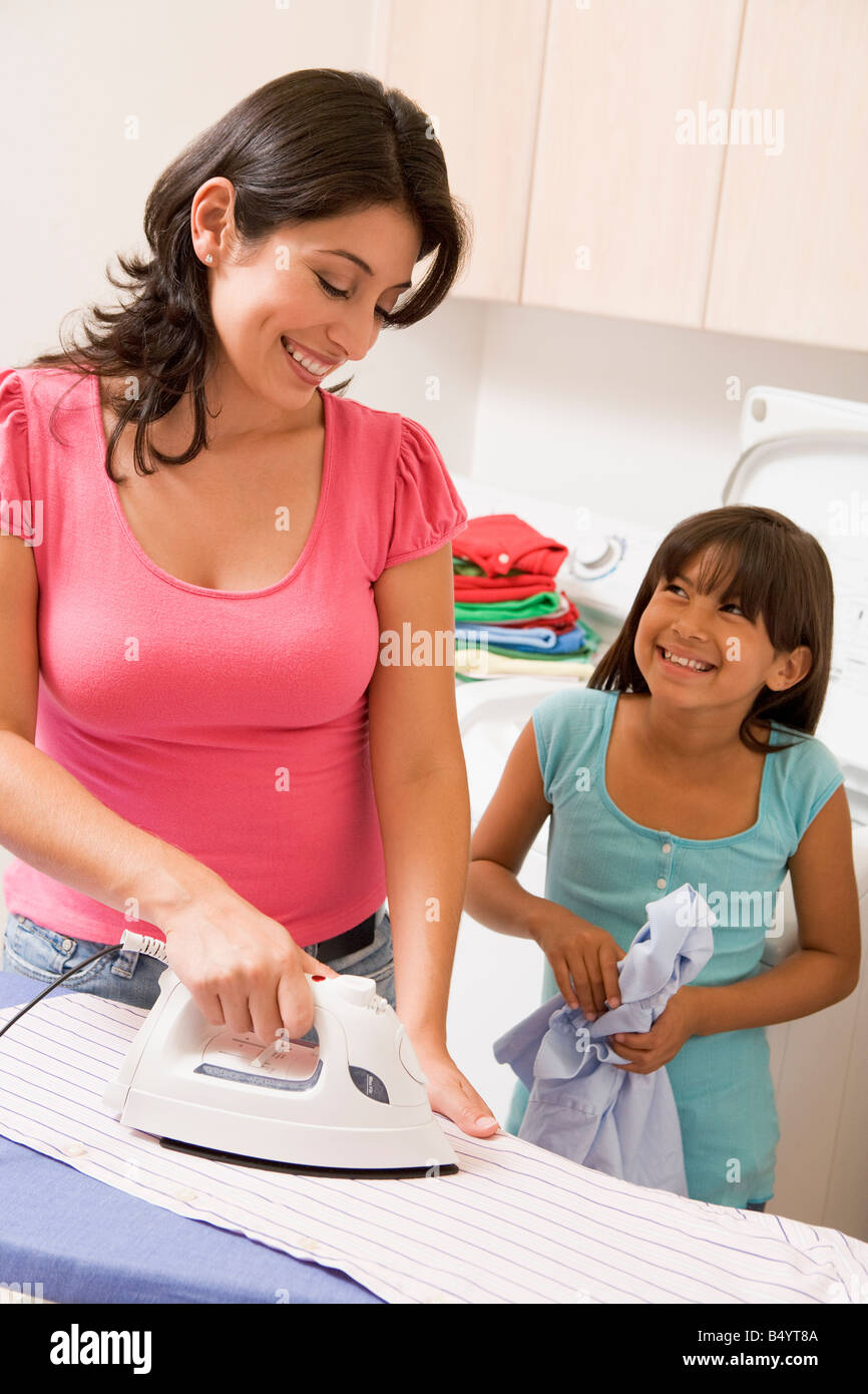 Mother And Daughter Ironing Stock Photo