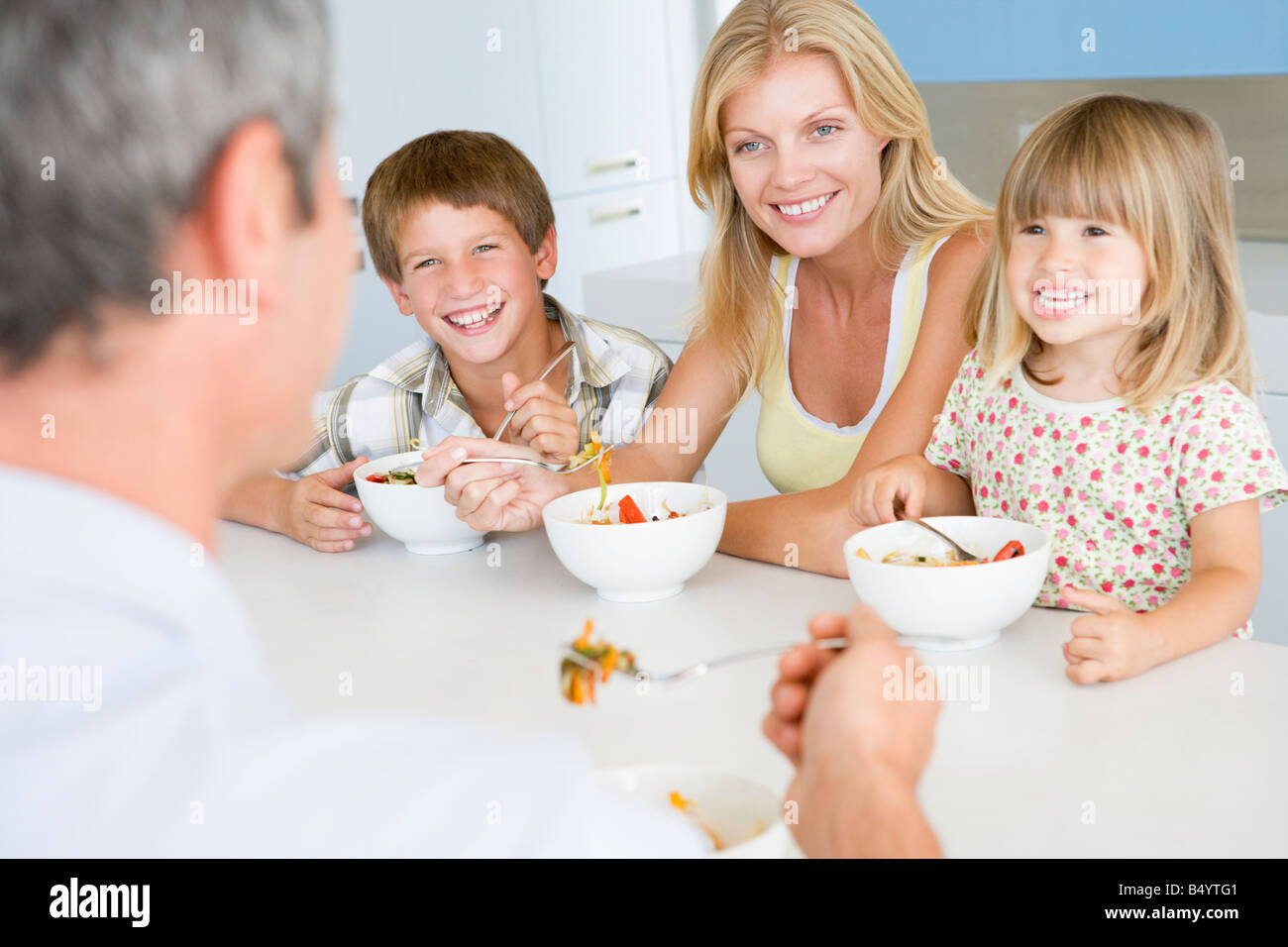 Family Eating A Meal Together Stock Photo