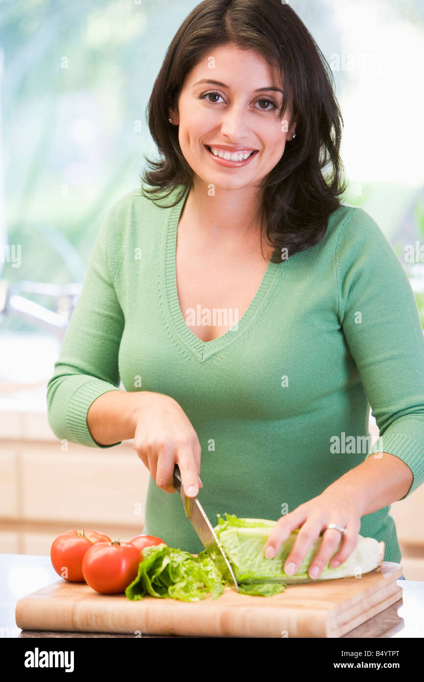 Woman Chopping Vegetables Stock Photo