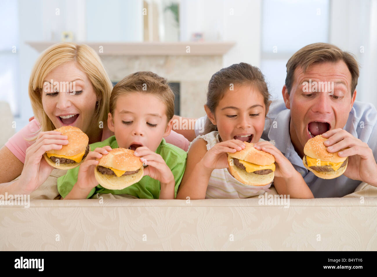 Family Eating Cheeseburgers Together Stock Photo