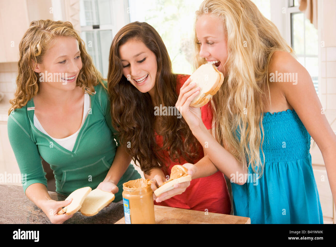 Teenage Girls Making Sandwiches Stock Photo