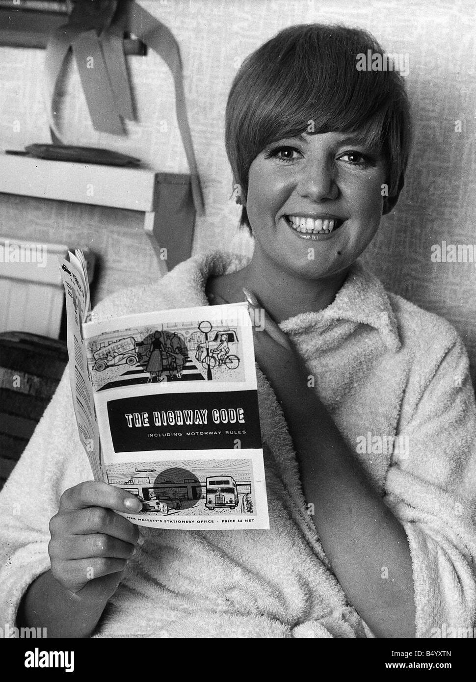 Cilla Black pop singer entertainer reading The Highway Code preparing