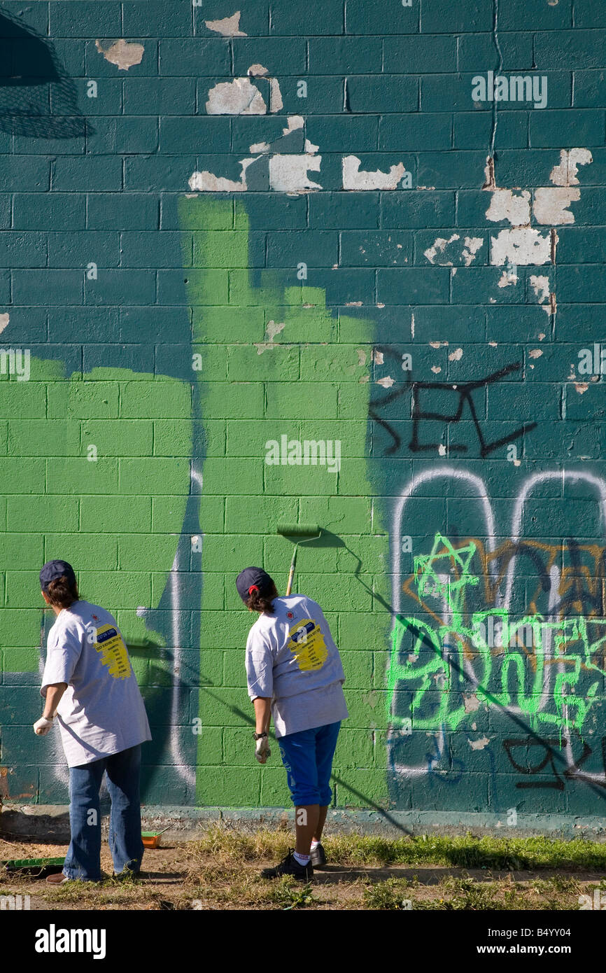 Volunteers Paint Over Graffiti Stock Photo Alamy