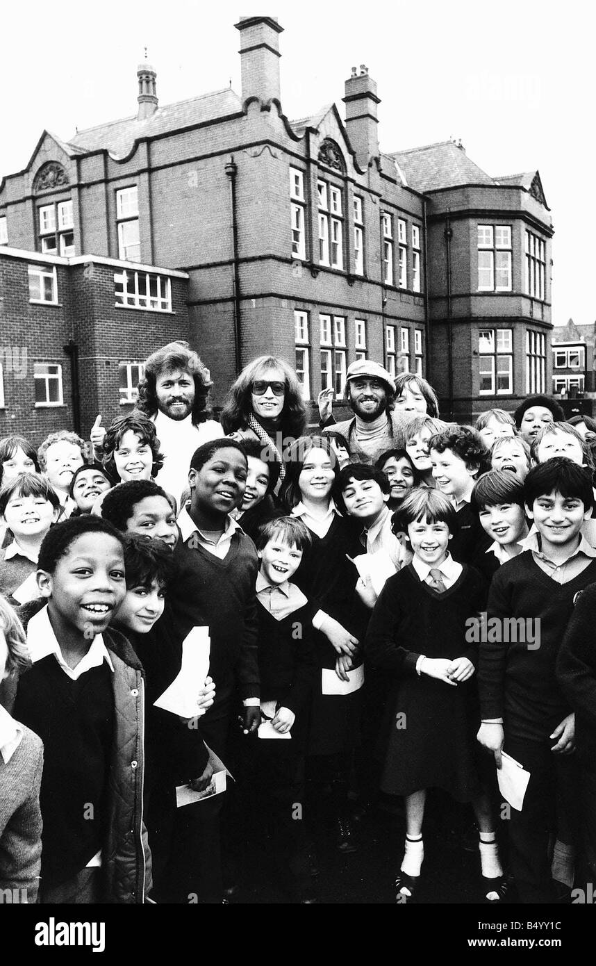 The Bee Gees pop group 1981 Barry Gibb Maurice Gibb Robin Gibb and schoolchildren Stock Photo