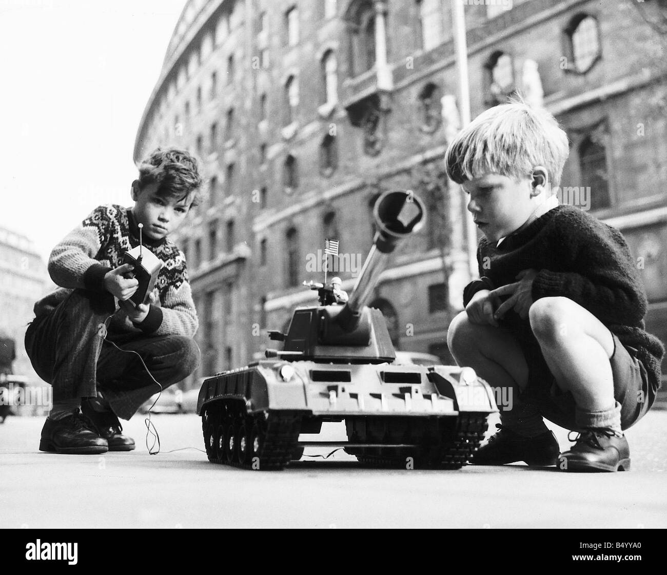 Two boys playing with Top Toy a remote controlled tank Stock Photo Alamy