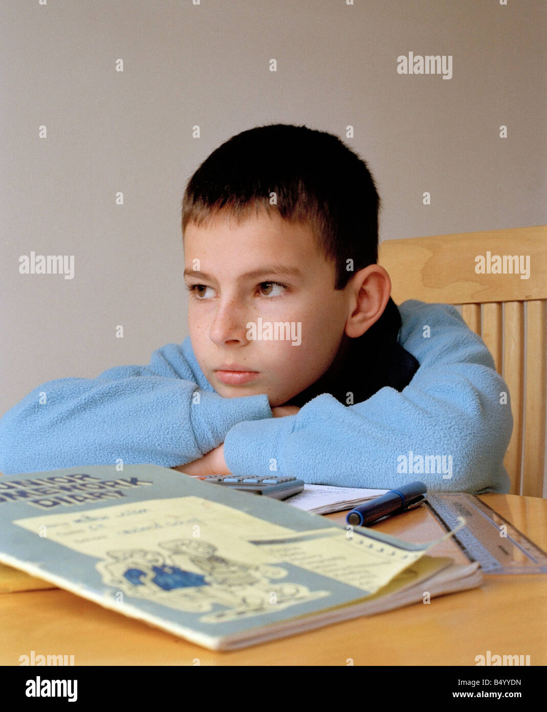 Bored boy doing his homework. Stock Photo