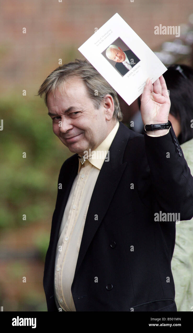 Ron Lynch, partner of the late John Inman, holds up a picture of John on  the memorial service shet at Golders Green Crematorium.;23rd March 2007  Stock Photo - Alamy