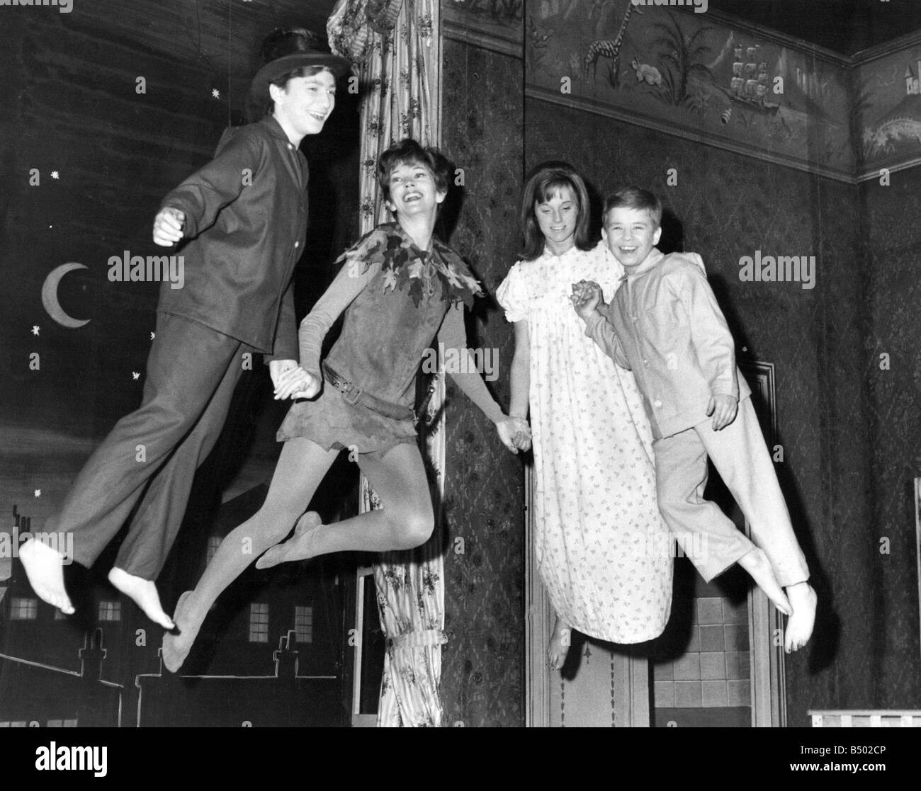 Peter Pan takes off Dawn Addams second from left with Alison Frazer as Wendy David Morris as John and Douglas Mann extreme right as Michael rehearse their flying act on the stage of the Scala Theatre London The show comes to Newcastle in March Stock Photo