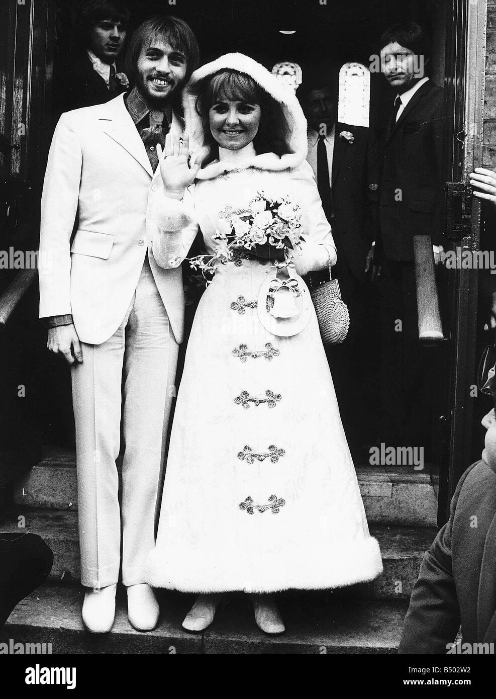 Maurice Gibb member of the pop group The Bee Gees stands with his new wife Singer Lulu outside St James Church in Gerrards Cross in Buckinghamshire Stock Photo