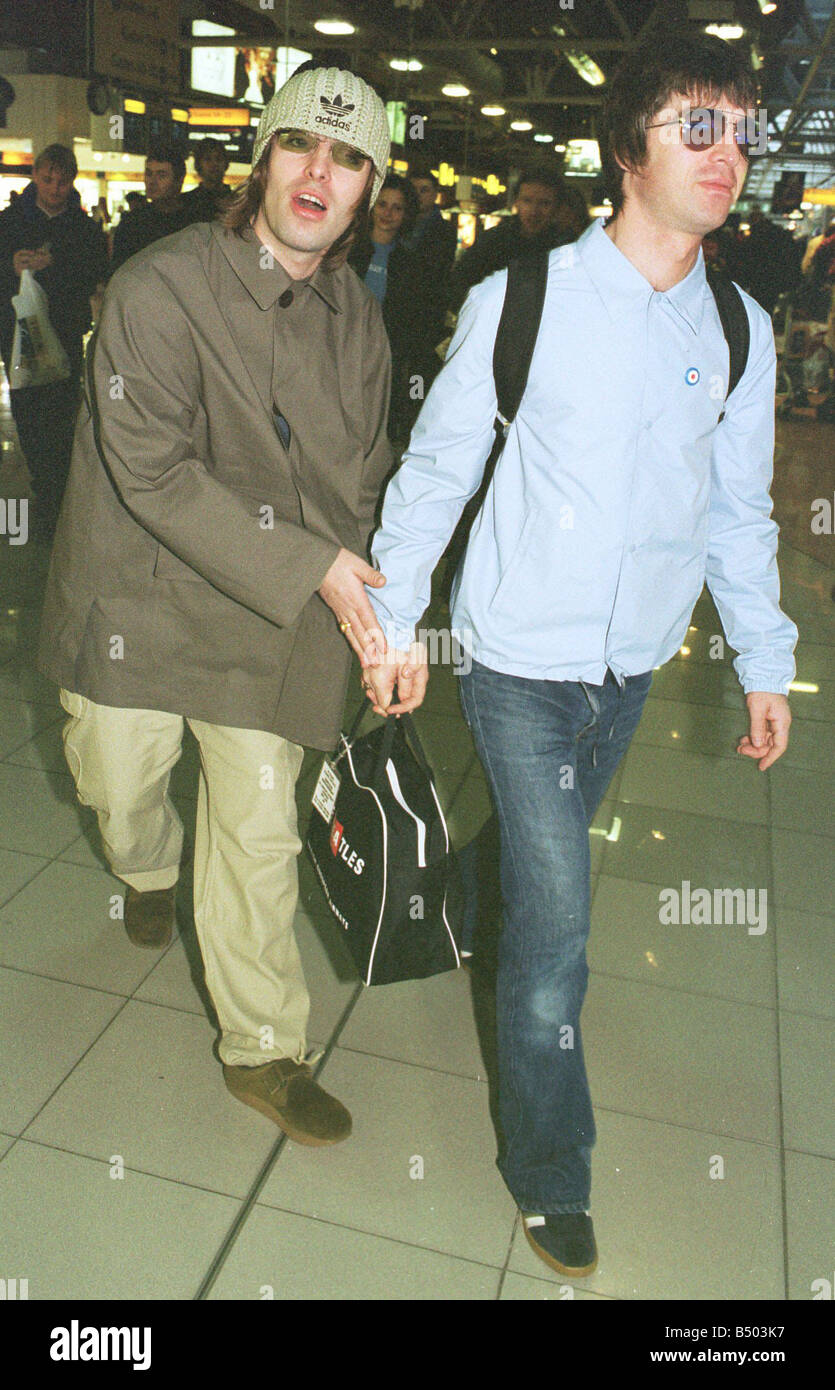 Brothers Liam and Noel Gallagher of Oasis leave Heathrow Airport for Japan and the start of a tour Stock Photo