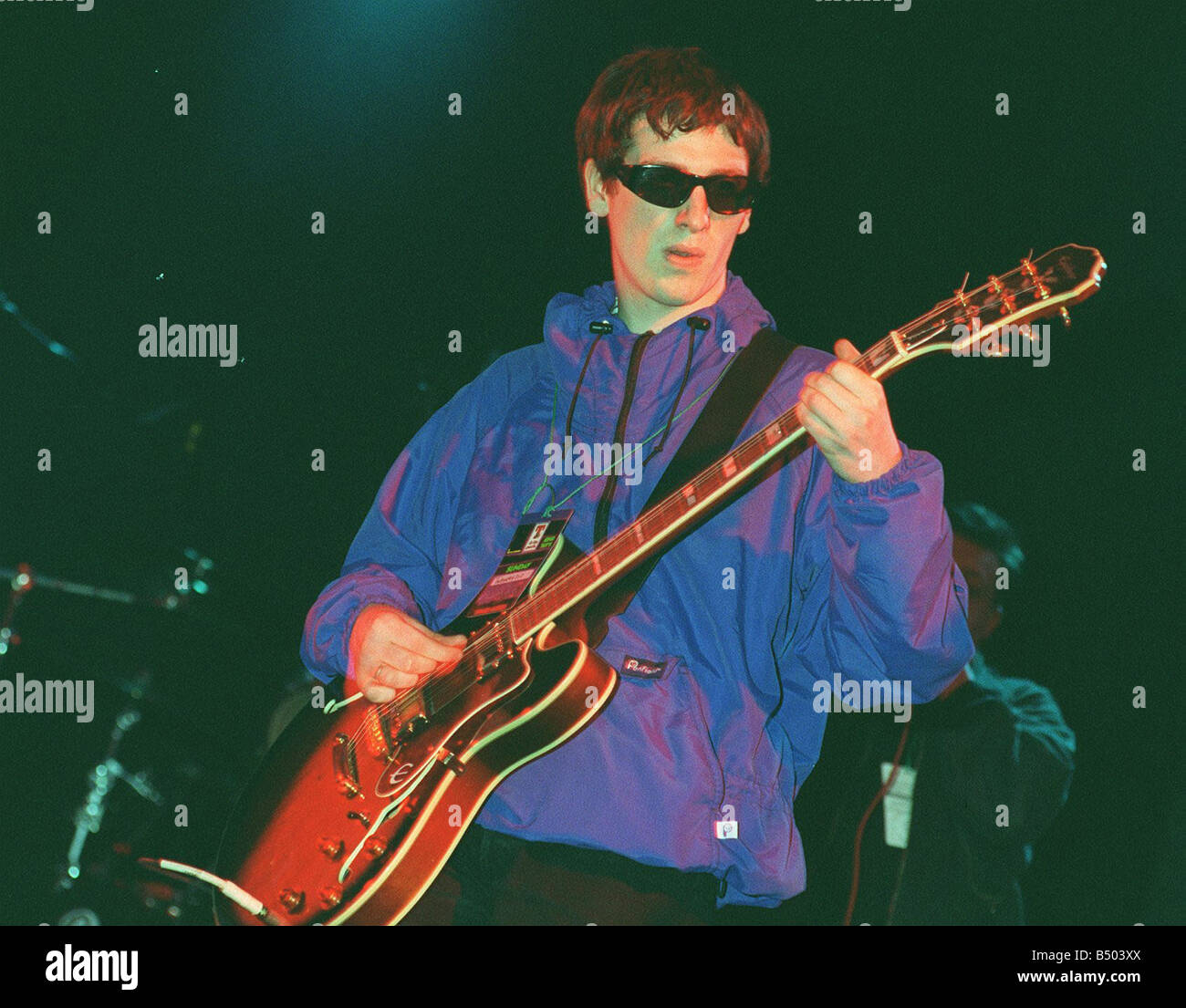 Guitarist with pop group Nowaysis Oasis tribute band at T in the Park on stage in NME Tent Sunday wearing blue jacket sunglasses Stock Photo