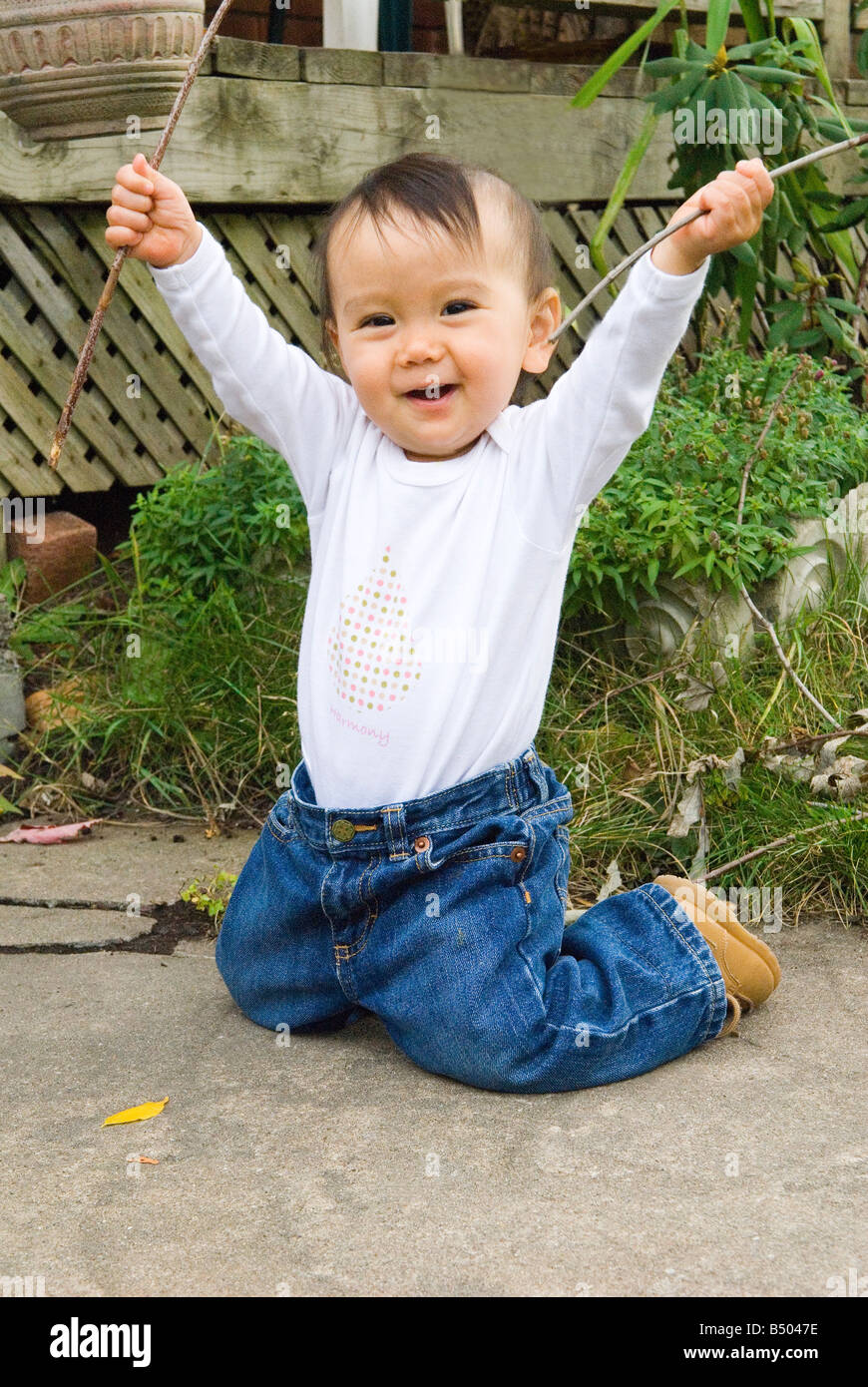 Baby girl waving arms high in the air Stock Photo Alamy