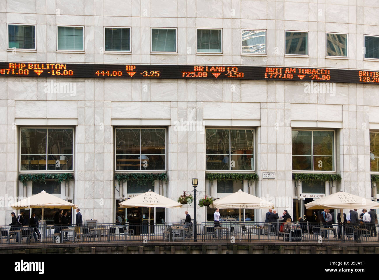 Stock prices falling on the Reuters ticker at Canary Wharf London England Stock Photo