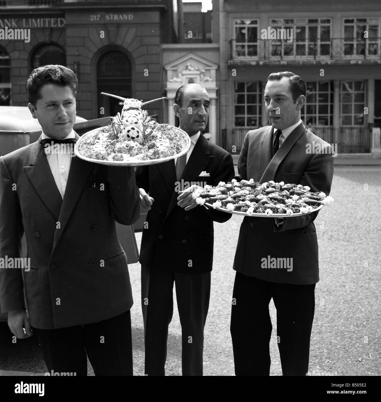 Restaurant men from the Caprice on their way to the Law Courts to serve lunch to millionaire Nubar Gulbenkian. The 66 year old millionaire is embroilled in a lawsuit against the BBC over the ' Face to Face' TV programme. ;July 1962;Q5948 Stock Photo