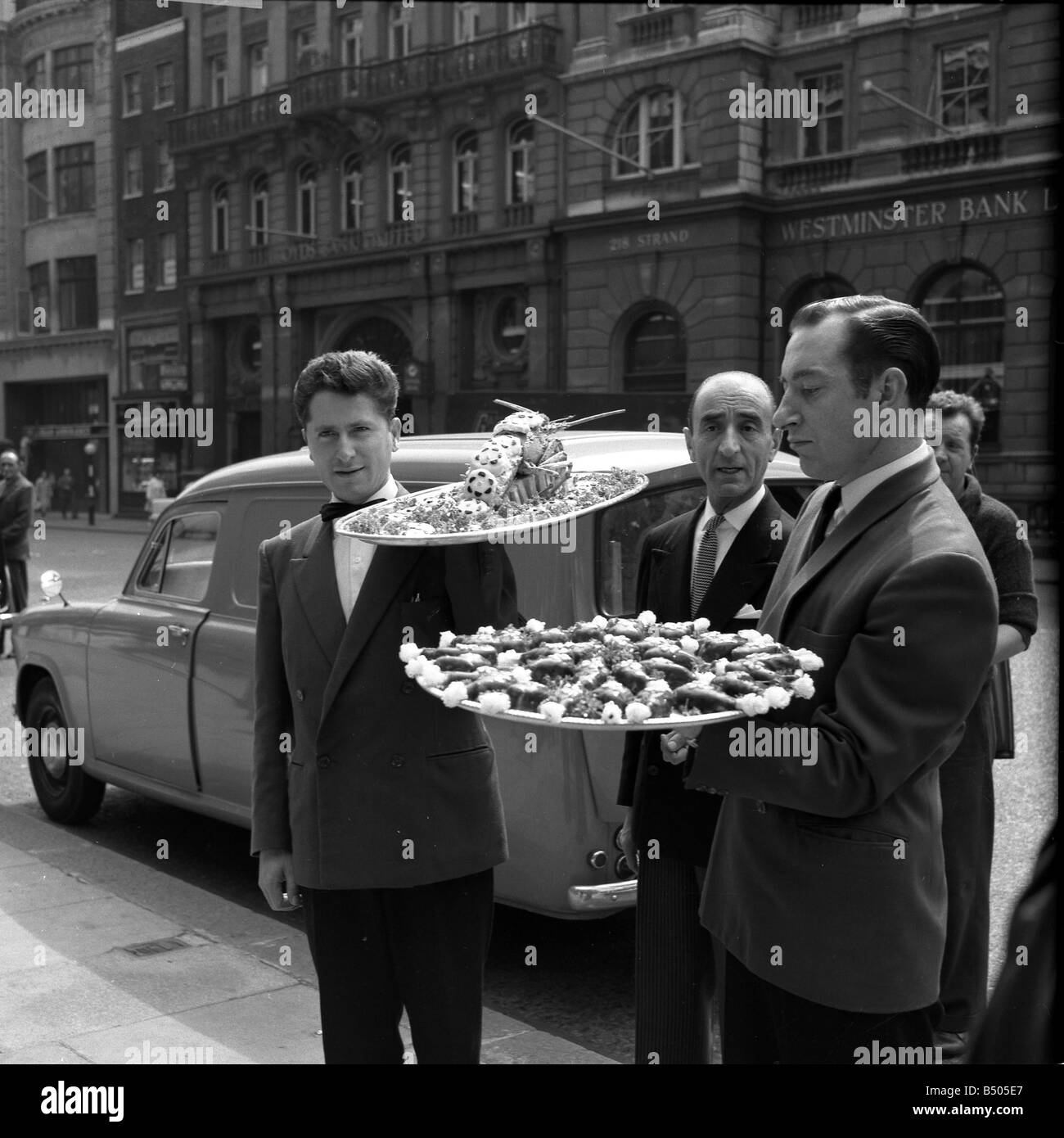 Restaurant men from the Caprice on their way to the Law Courts to serve lunch to millionaire Nubar Gulbenkian. The 66 year old millionaire is embroilled in a lawsuit against the BBC over the ' Face to Face' TV programme. ;July 1962;Q5948 Stock Photo