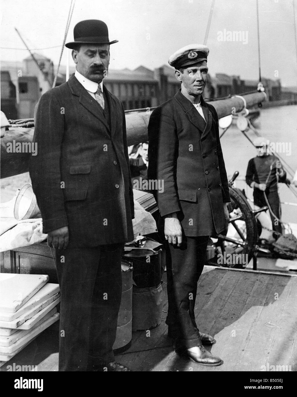Alfred Cheetham (right) third officer on the Endurance seen here on deck as the ship departs UK shores in August 1914 Cheetham served under Scott on the 'Morning' ( relief of the 'Discovery') , and the 'Terra Nova'. And under Shackleton on 'Nimrod ', where he was third officer and boatswain, and of course the 'Endurance' as 3rd Officer in charge of the fo'c's'le ( forecastle) crew. Cheetham was a significant figure in antarctic exploration in his own right, making four trips to Antarctica. He died whilst serving in the Merchant marine during the First World War. Stock Photo