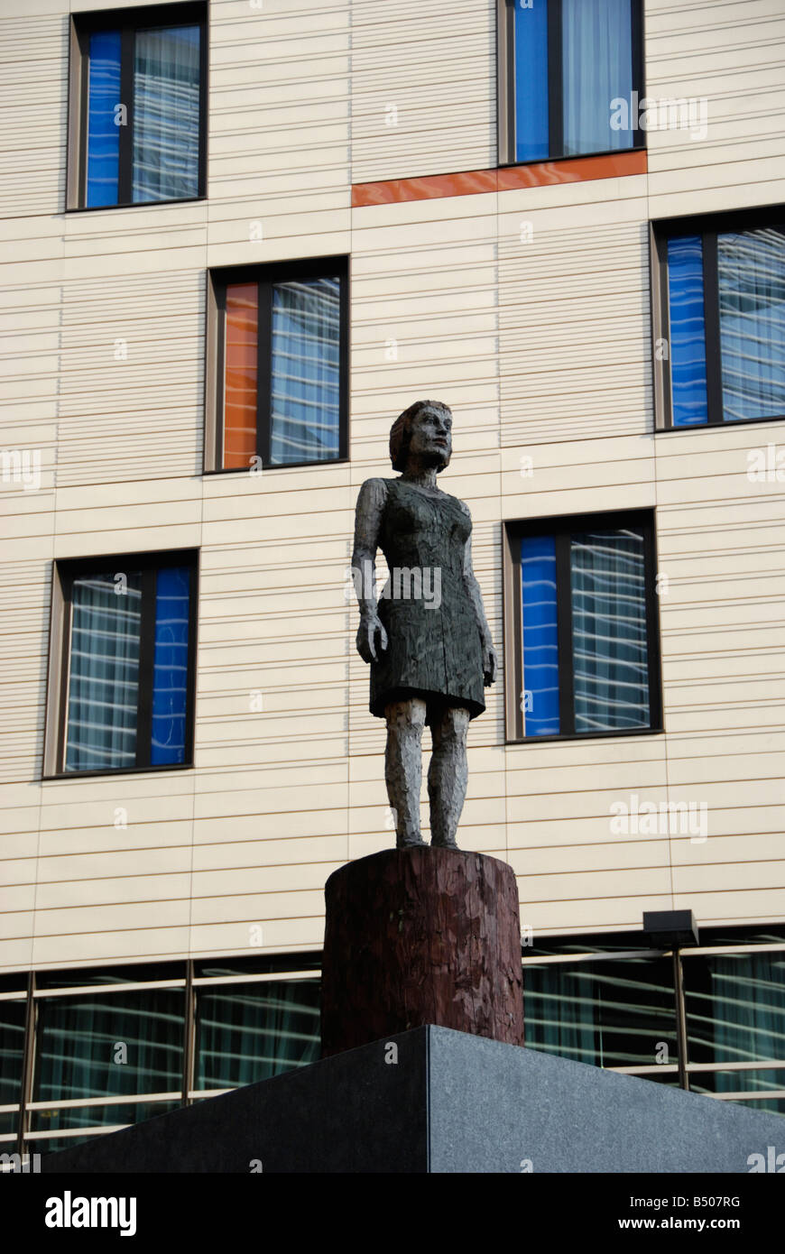 Wooden statue of female office worker and contemporary building at the More London development London England Stock Photo