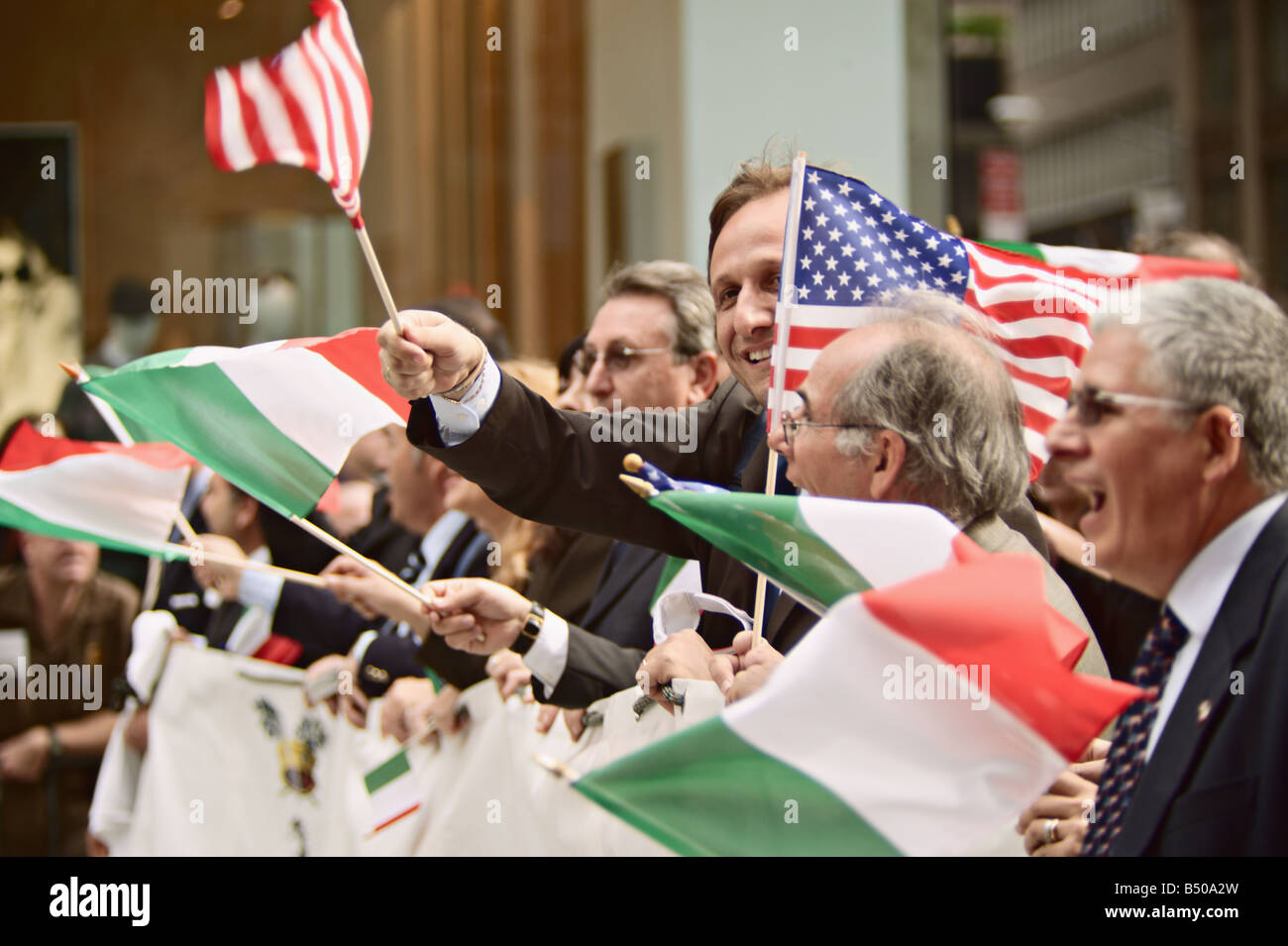 Group waving American and Italian flags while marching in 2008 Columbus Day Parade New York New York US Stock Photo
