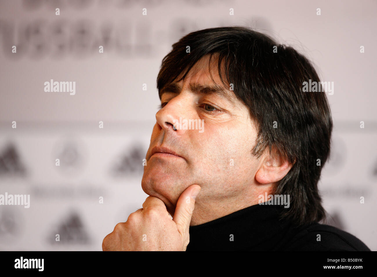 The federal coach of the German Football Association Joachim Loew shows his sceptical attitude during a press conference Stock Photo