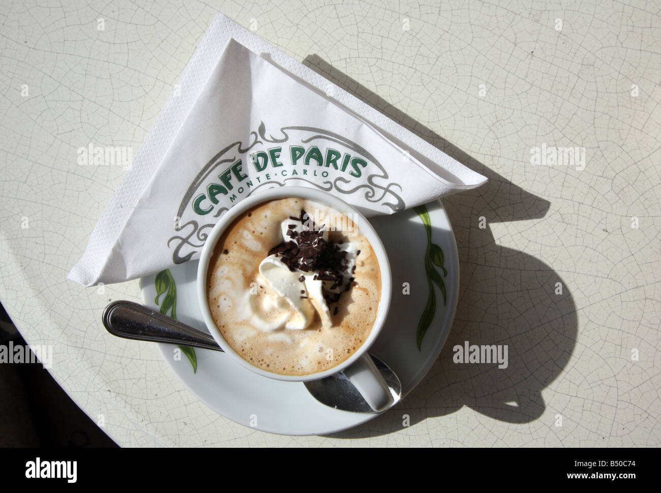 Coffee cup with chantilly cream topping at Cafe De Paris Monte Carlo Monaco. Cafe de Paris is outside the famous casino. Stock Photo