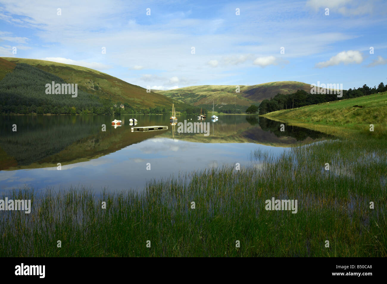 With boats moored by the sailing clubhouse, looking North across St Mary's Loch from Tibbie Shiel's Inn. Scottish Borders Stock Photo