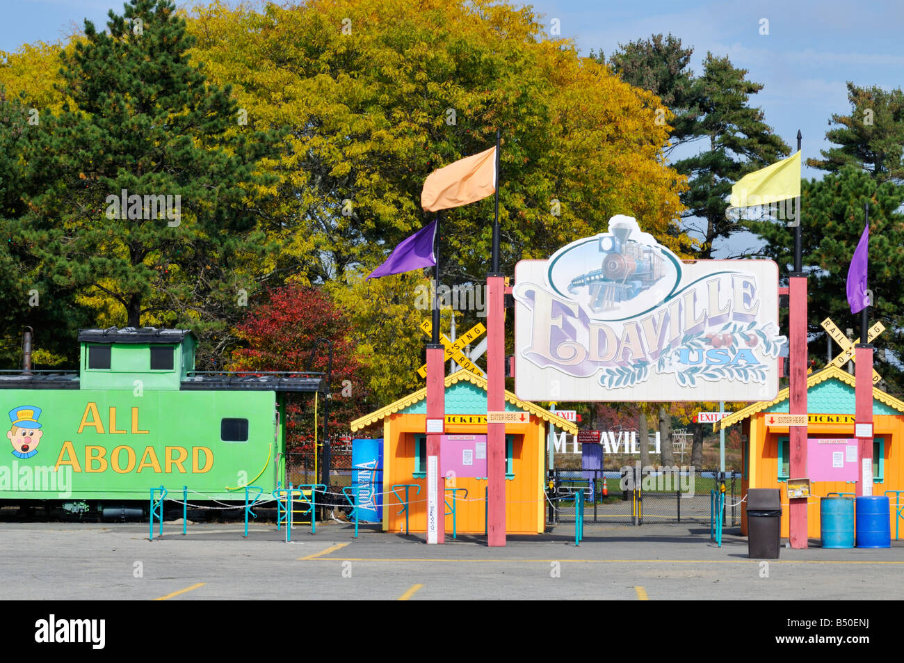 Signs, flags and bright, colorful ticket booths at entrance to Edaville Railroad in Carver, Plymouth County, MA, USA Stock Photo