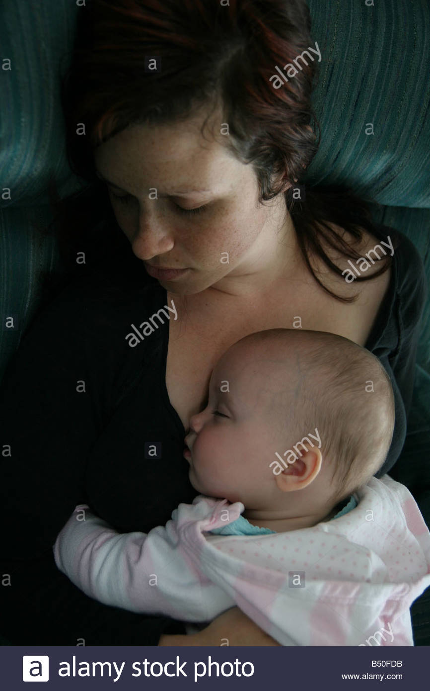 mom sleeping with baby on chest