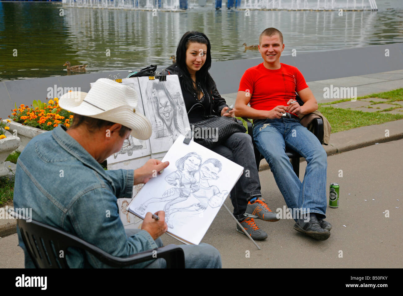 Sep 2008 - Young couple having their portrait at painted at Gorky Park Moscow Russia Stock Photo
