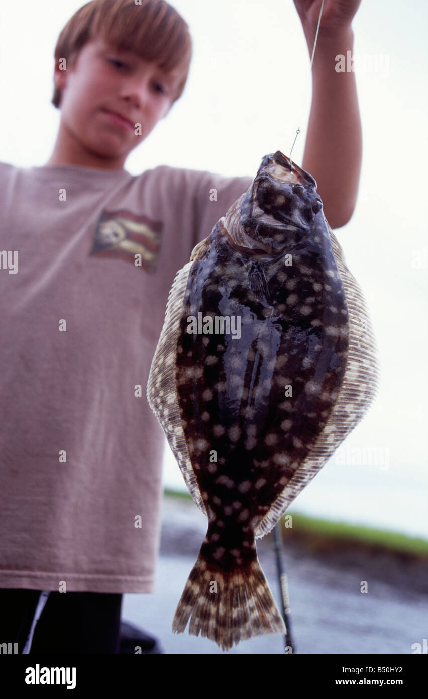 Boy holding a flounder that he just caught Fernandina Beach Amelia
