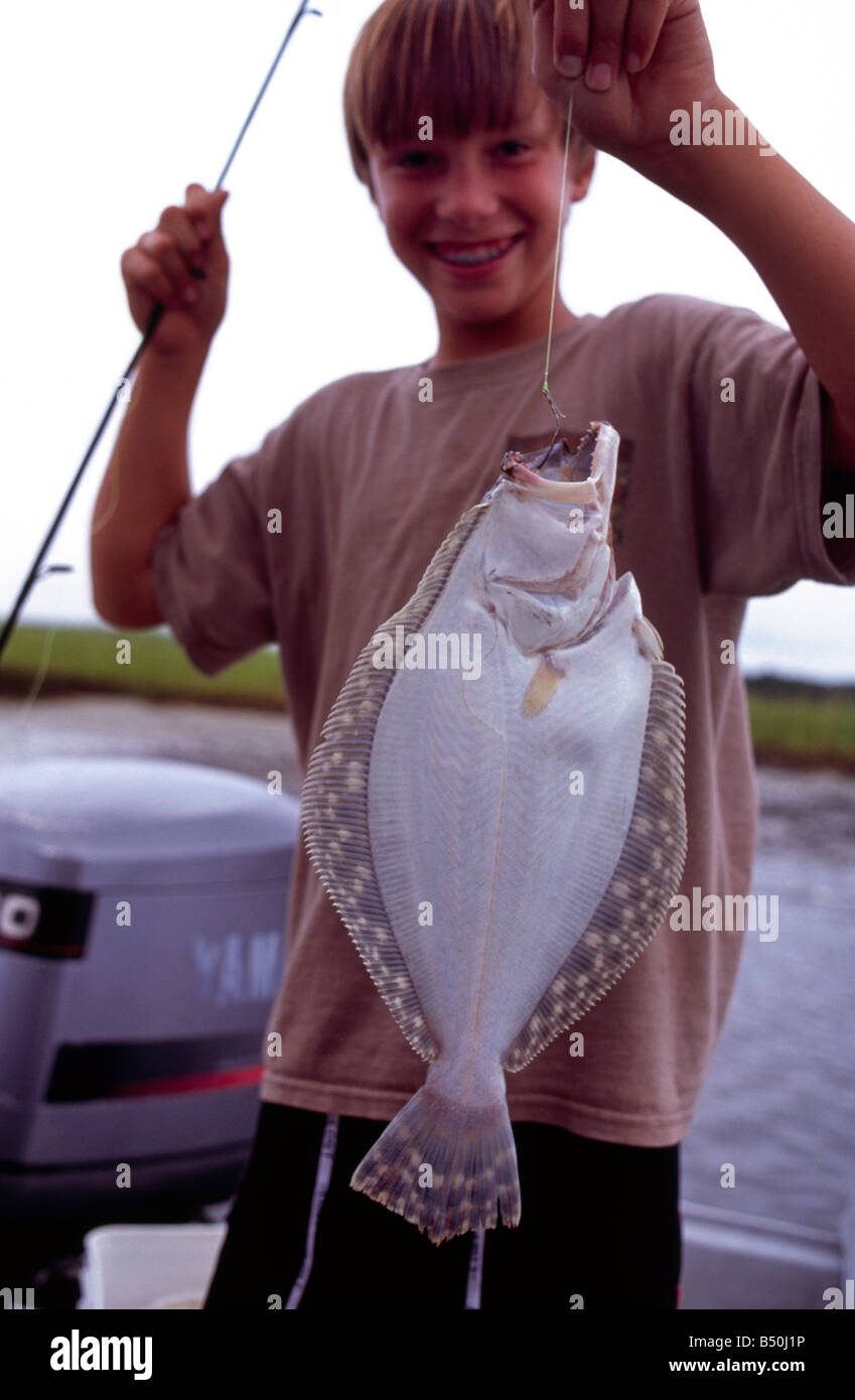 Boy holding a flounder that he just caught Fernandina Beach Amelia