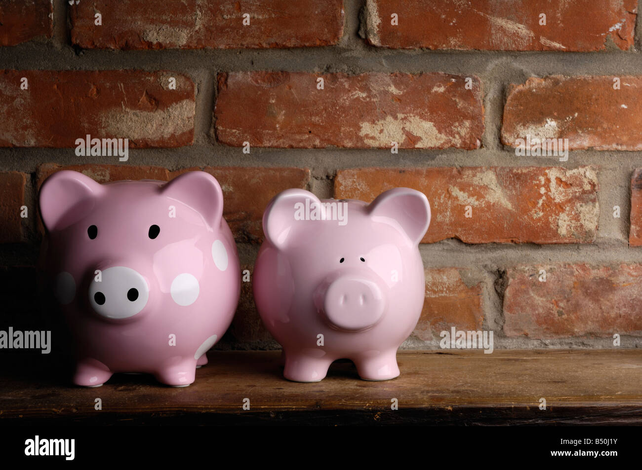 Two piggy banks on a shelf Stock Photo Alamy