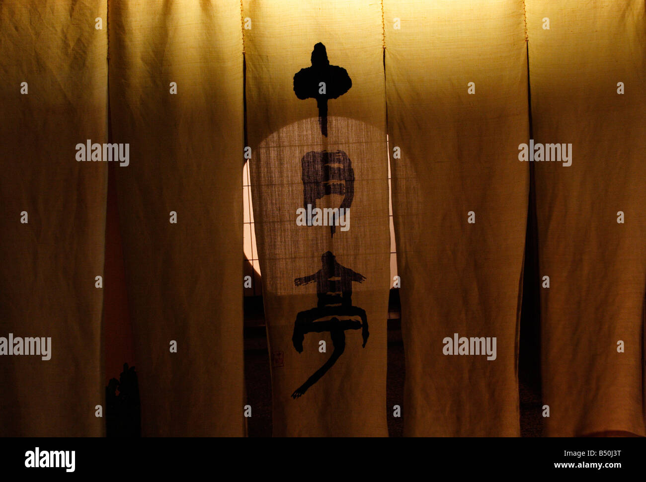 Noren curtains with a moon door behind in a teahouse in the old geisha quarter of Higashi Chaya in Kanazawa, Japan Stock Photo