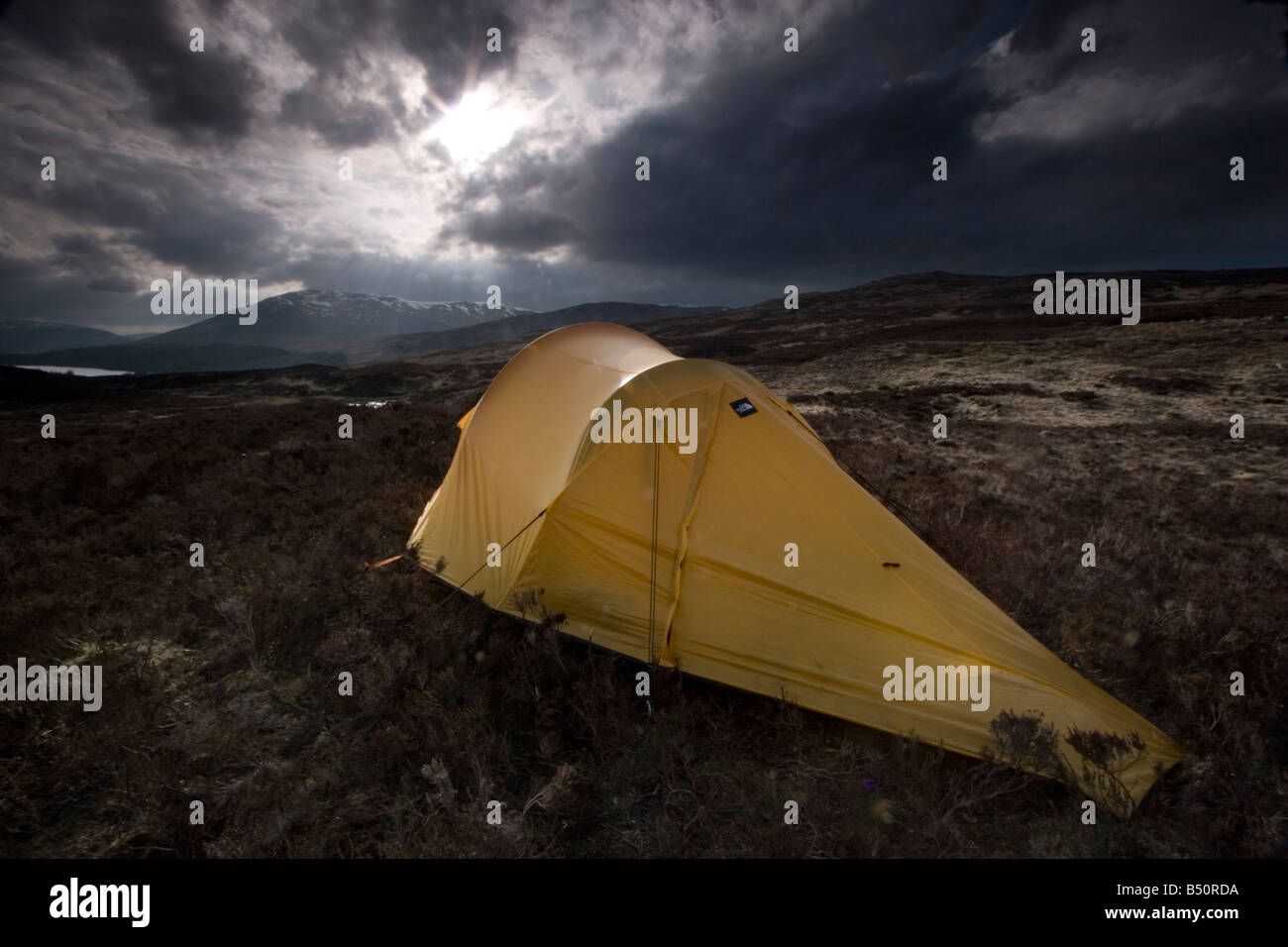 Orange mountain tent with dramatic clouds Stock Photo - Alamy