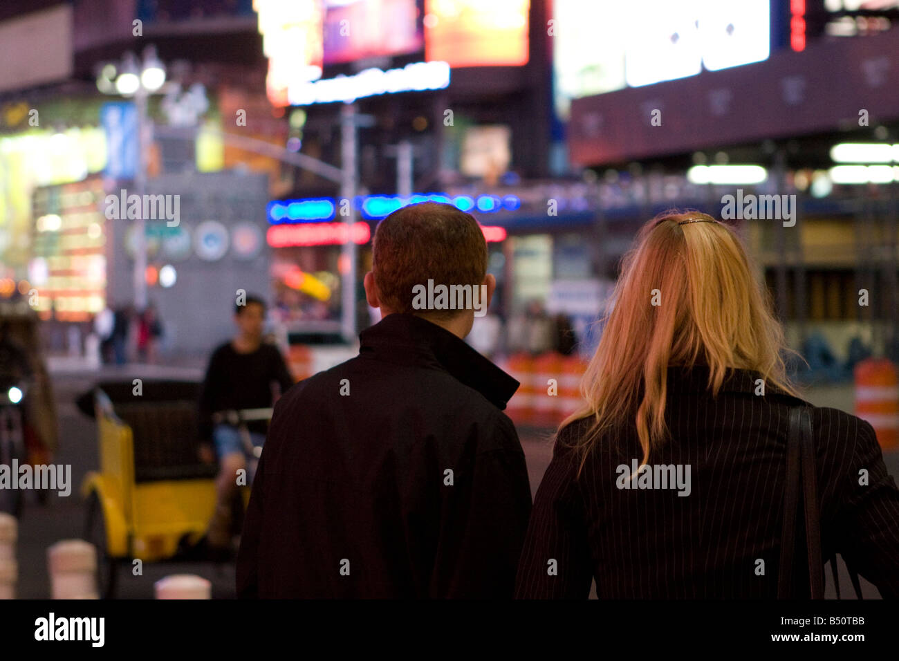 Turist glancing at times square at night Stock Photo