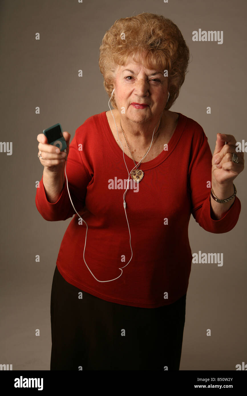 Senior citizen grooving to tunes on an iPod Stock Photo