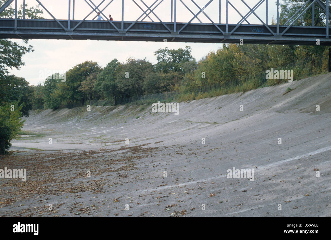 Brooklands Motor-racing circuit near Weybridge, Surrey, part of the banked track, built 1907, and pedestrian bridge over. Stock Photo