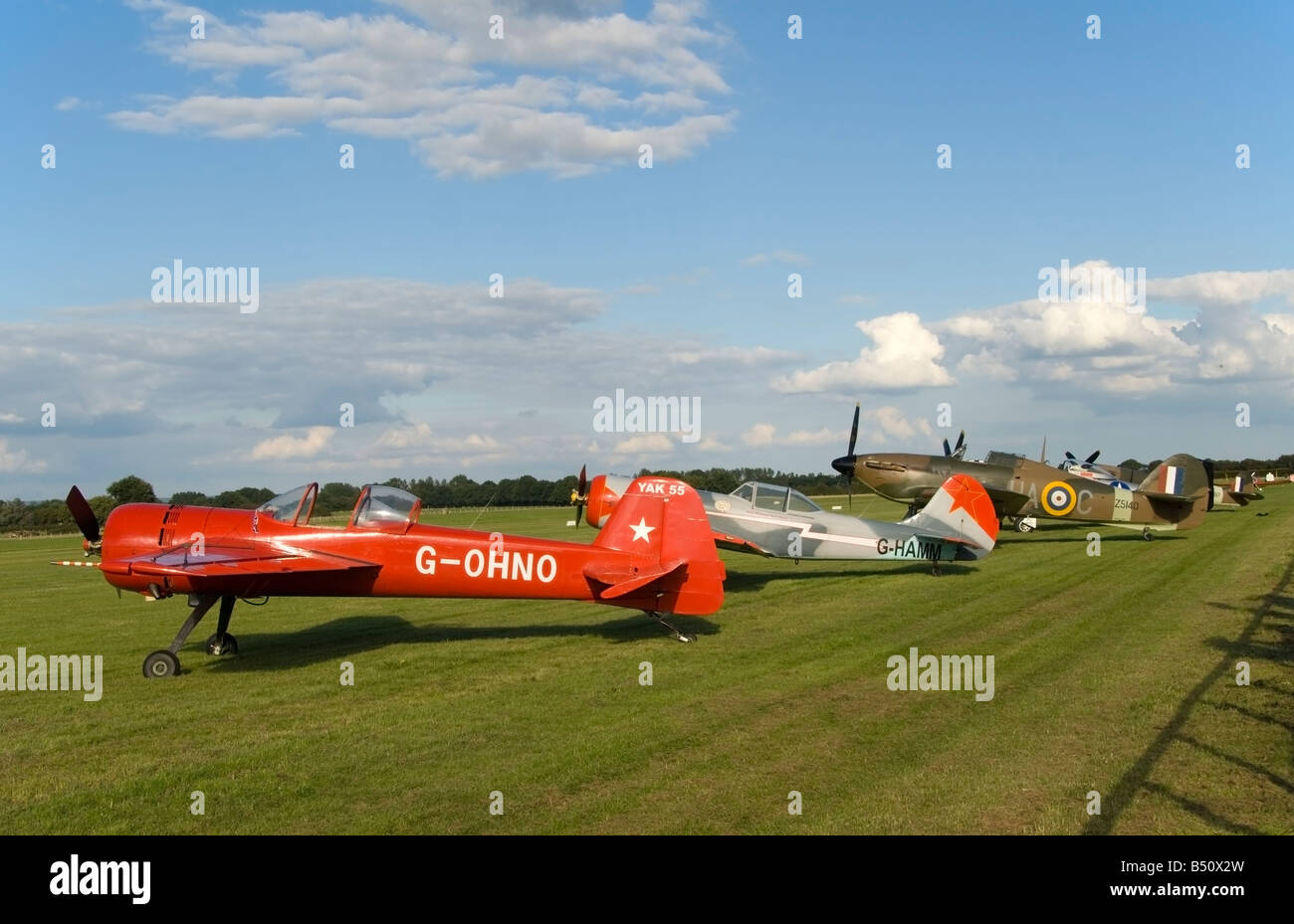 Yak 55, Yak 50 and Hurricane aircraft lined up at Headcorn, Kent Stock Photo