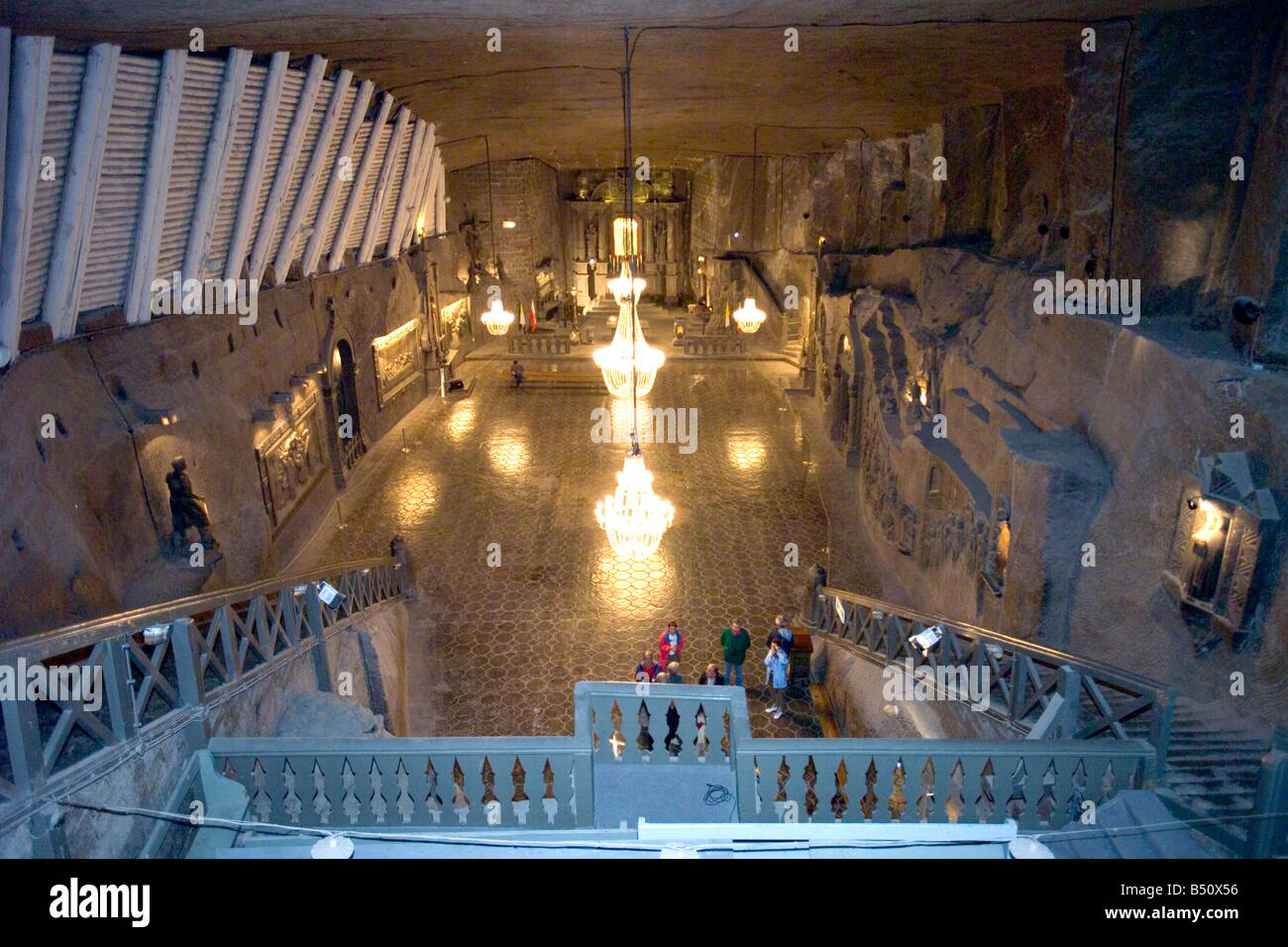 An Aerial view of tourists in St Kinga's Chapel of the Wieliczka Salt Mines showing the large chandeliers carved from rock salt. Stock Photo