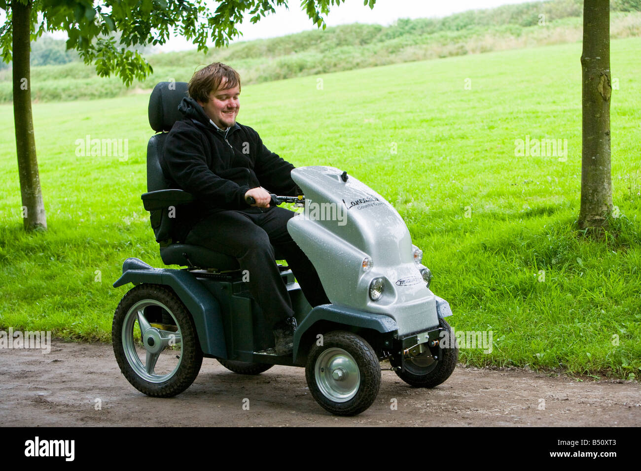 disabled man using an all terrain electric vehicle Stock Photo Alamy