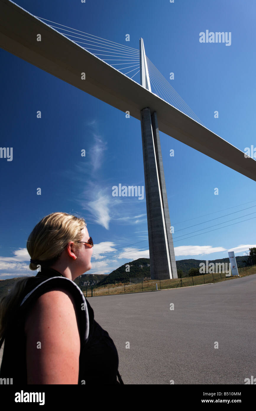 A woman looking up at the Millau Viaduct Stock Photo
