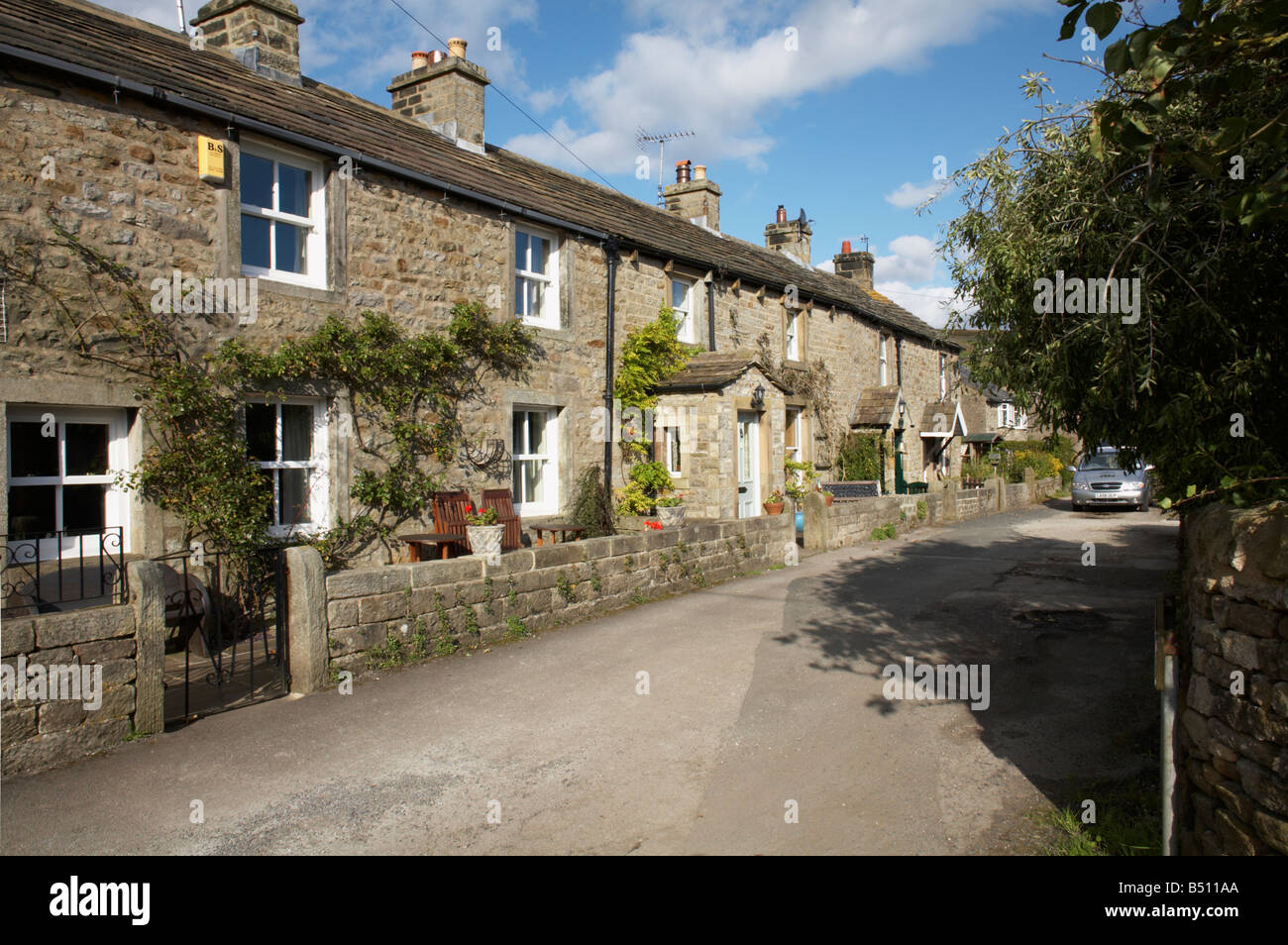 On a sunny October day, a row of traditional stone-built cottages at Hebden, North Yorkshire Stock Photo