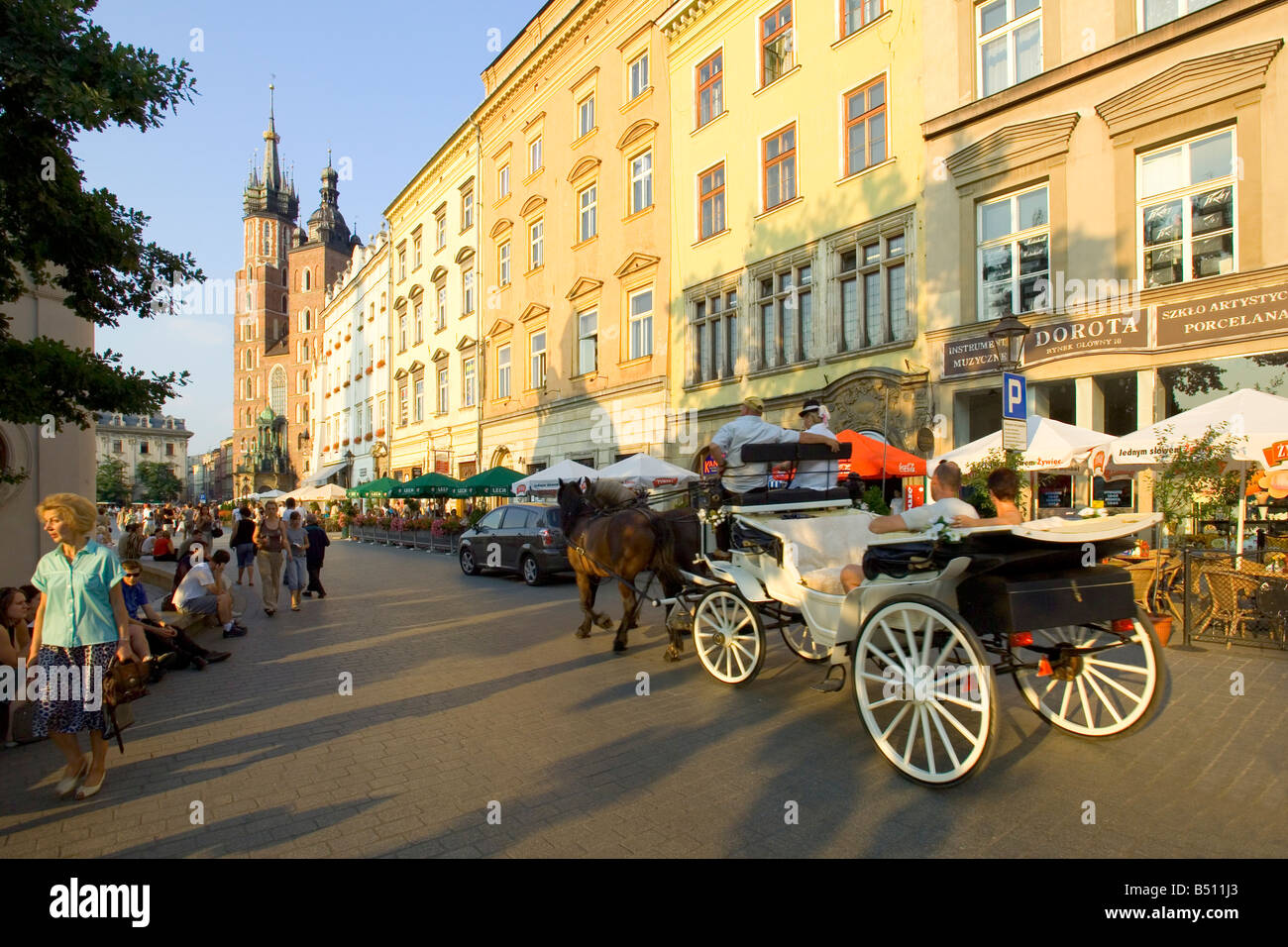 A tourist horse drawn carriage in the Main Market Square of Krakow in Poland. Stock Photo