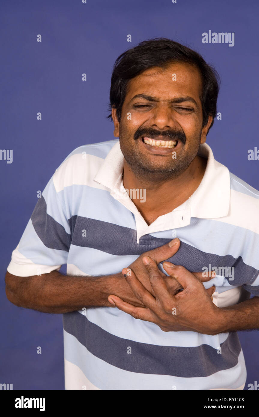 Indian man having a heart attack Stock Photo