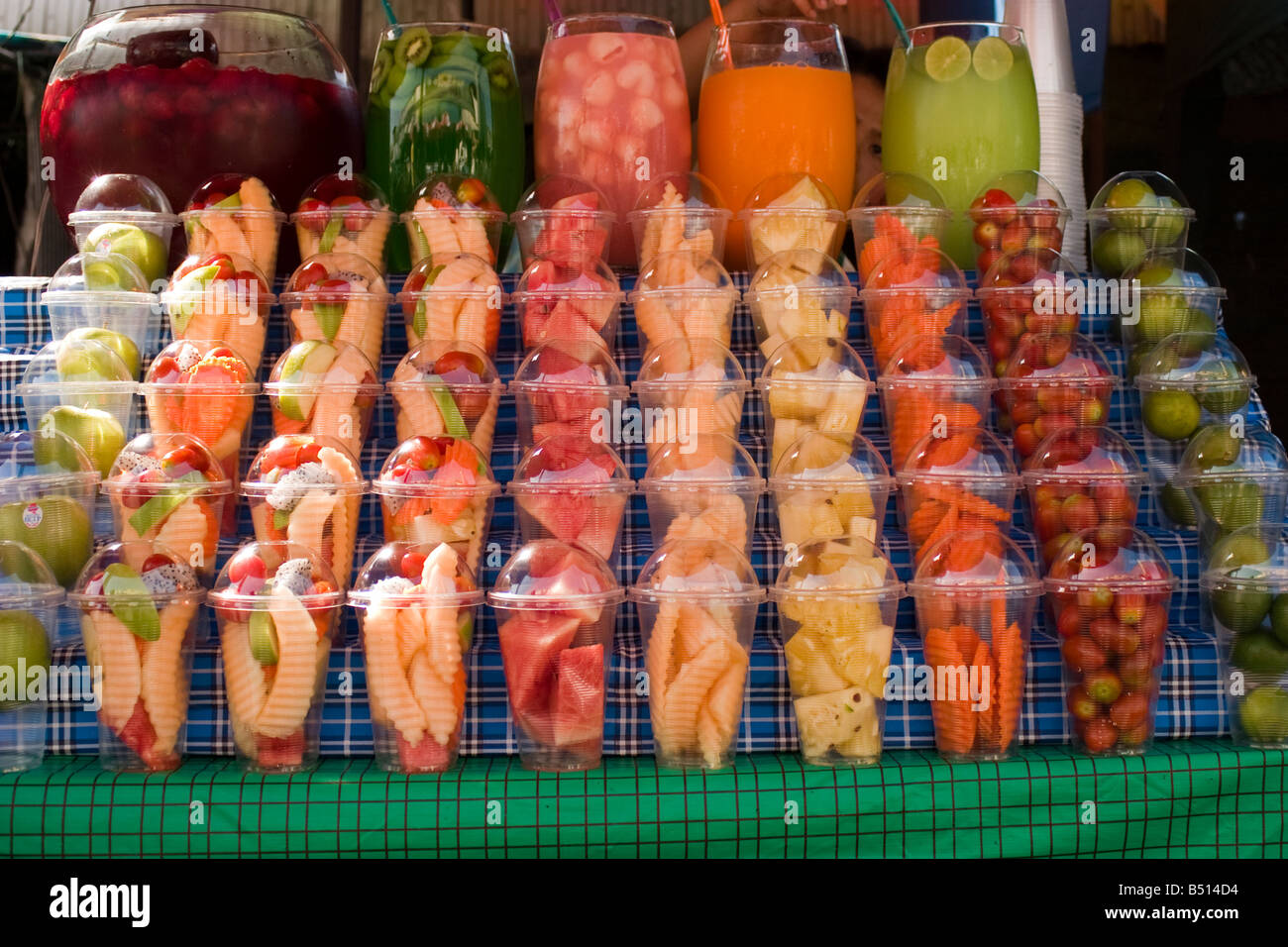 Pots of fruits are neatly lined up for sale at a market stall in Bangkok Stock Photo